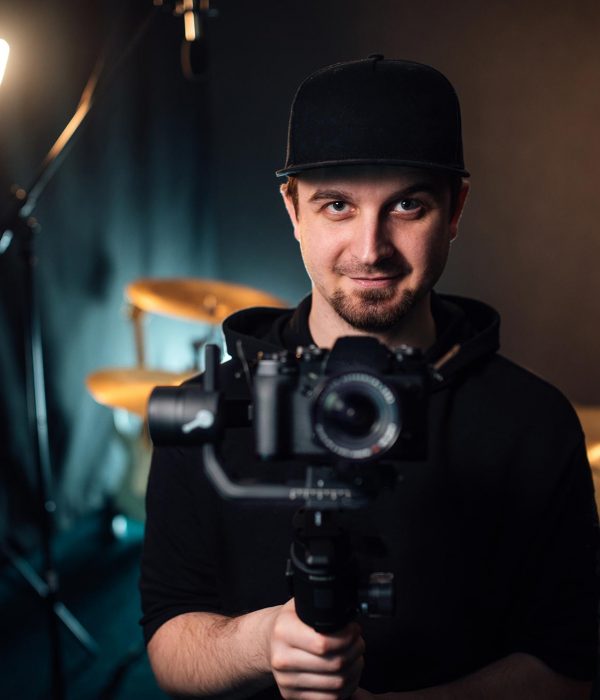 young-professional-videographer-holding-camera-on-resize.jpg